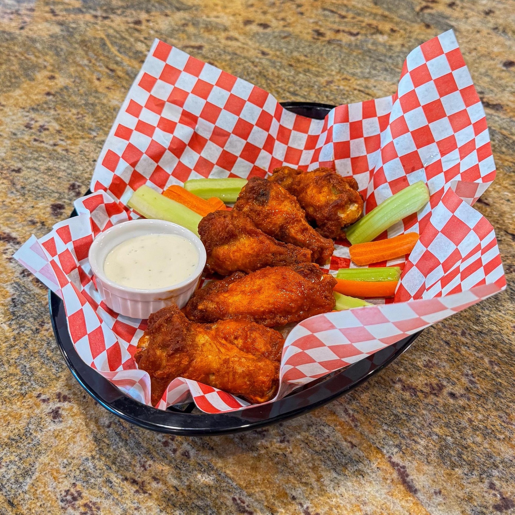 Buffalo wings with celery and carrots